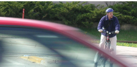 Subject: Bicyclist waiting for traffic; Location: John Nolen Drive, Madison, WI; Date: 2005; Photographer: Carrie Scherpelz